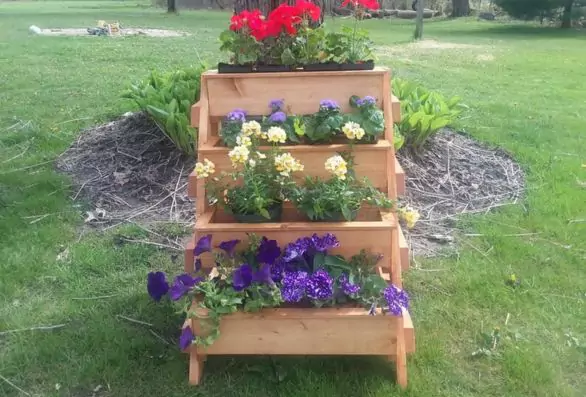 4 Tier planter stand with (4) planters on it